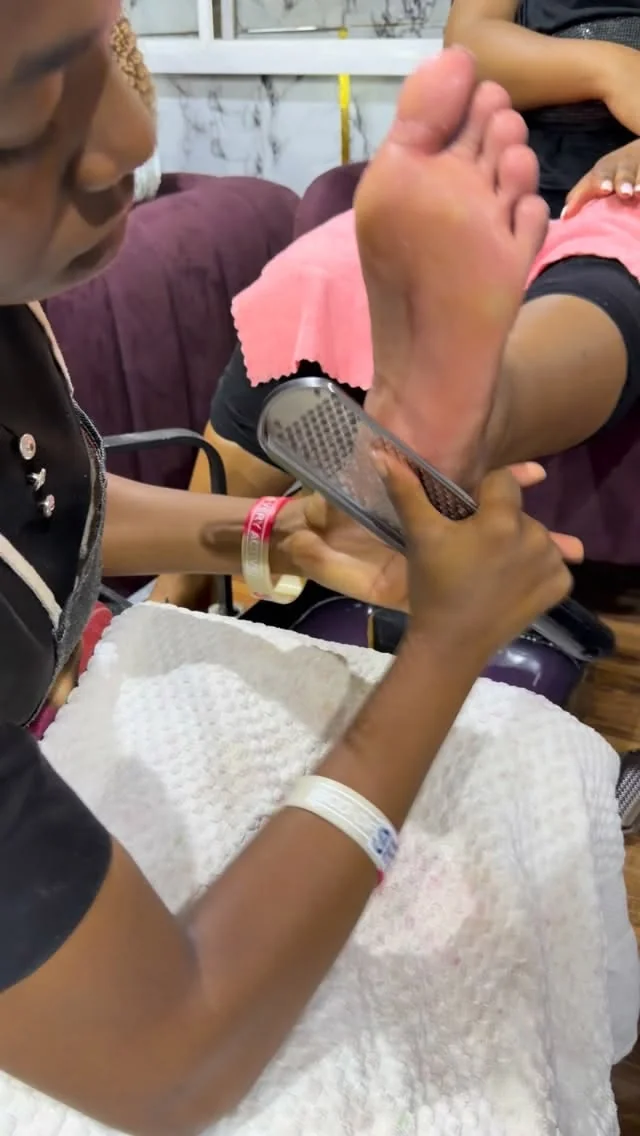Classic pedicure at SS Braids GH Accra — polish application and foot exfoliation on dark skin — photo 2 at SS BRAIDS GH Accra
